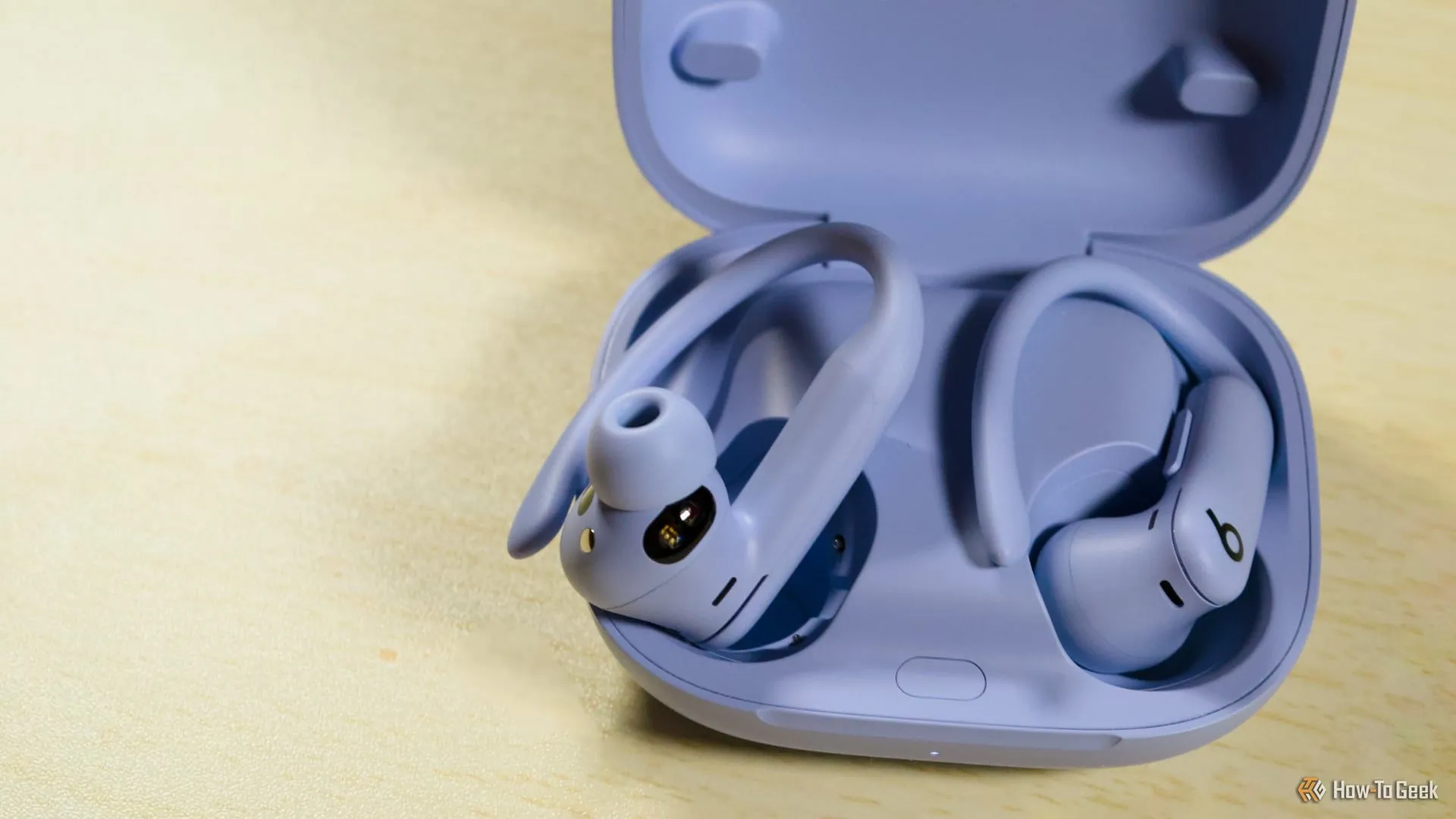 Tai nghe PowerBeats Pro 2 màu đen đang đặt một phần trong hộp sạc