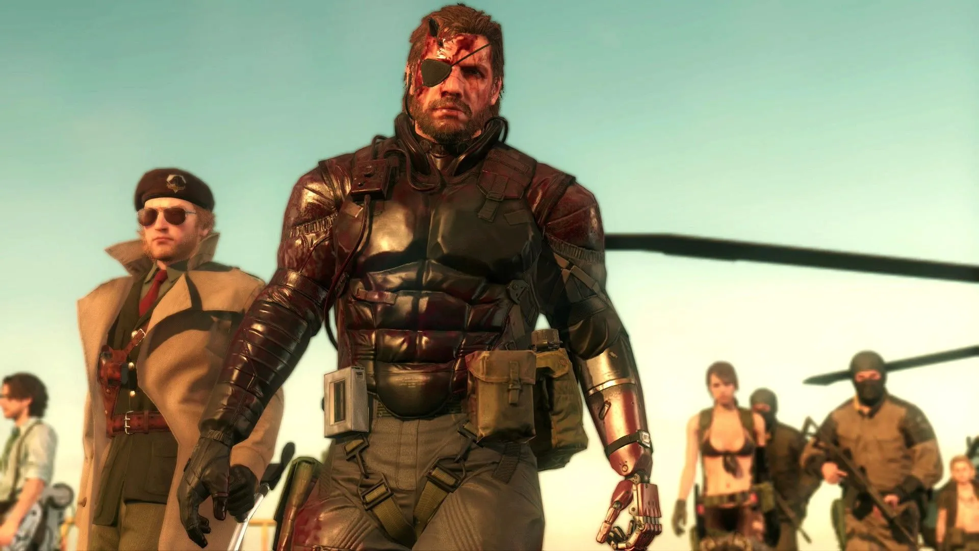 Các nhân vật Huey Emmerich, Kazuhira Miller, Venom Snake và Quiet cùng binh lính đang theo dõi màn hình, thể hiện sự phức tạp của cốt truyện Metal Gear Solid V Phantom Pain.
