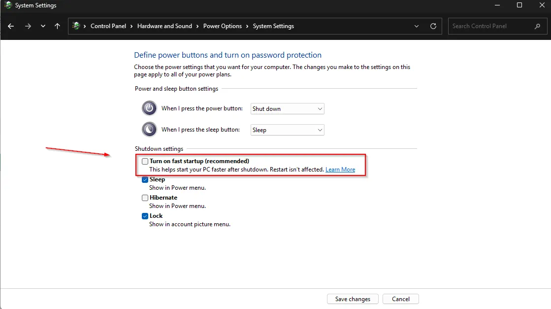 Cài đặt tùy chọn nguồn trong Windows 11, hiển thị hộp thoại &quot;System Settings&quot; với tùy chọn &quot;Turn on fast startup&quot; được bỏ chọn và mũi tên đỏ chỉ rõ.