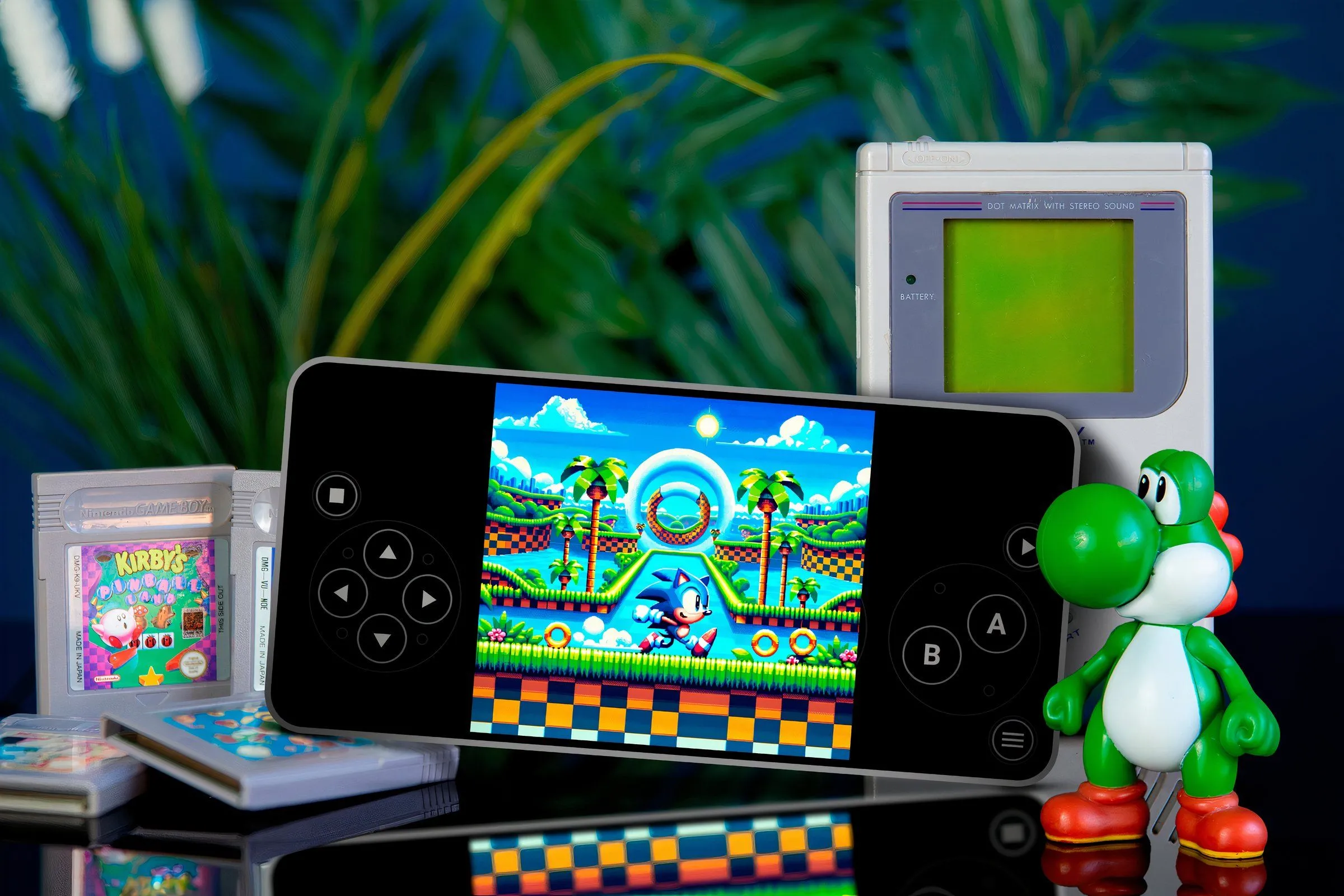 Điện thoại chạy game Sonic trên trình giả lập cùng với các băng game xung quanh, nhân vật Yoshi bên phải và máy Game Boy phía sau.