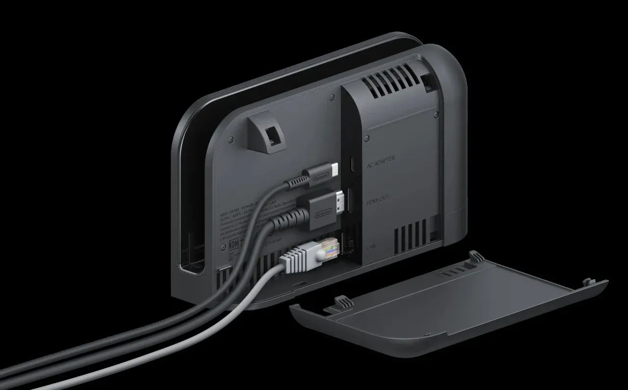 Dock của Nintendo Switch 2 với thiết kế lớn hơn, bo tròn và không có máy console bên trong, thể hiện cổng kết nối và khe tản nhiệt.