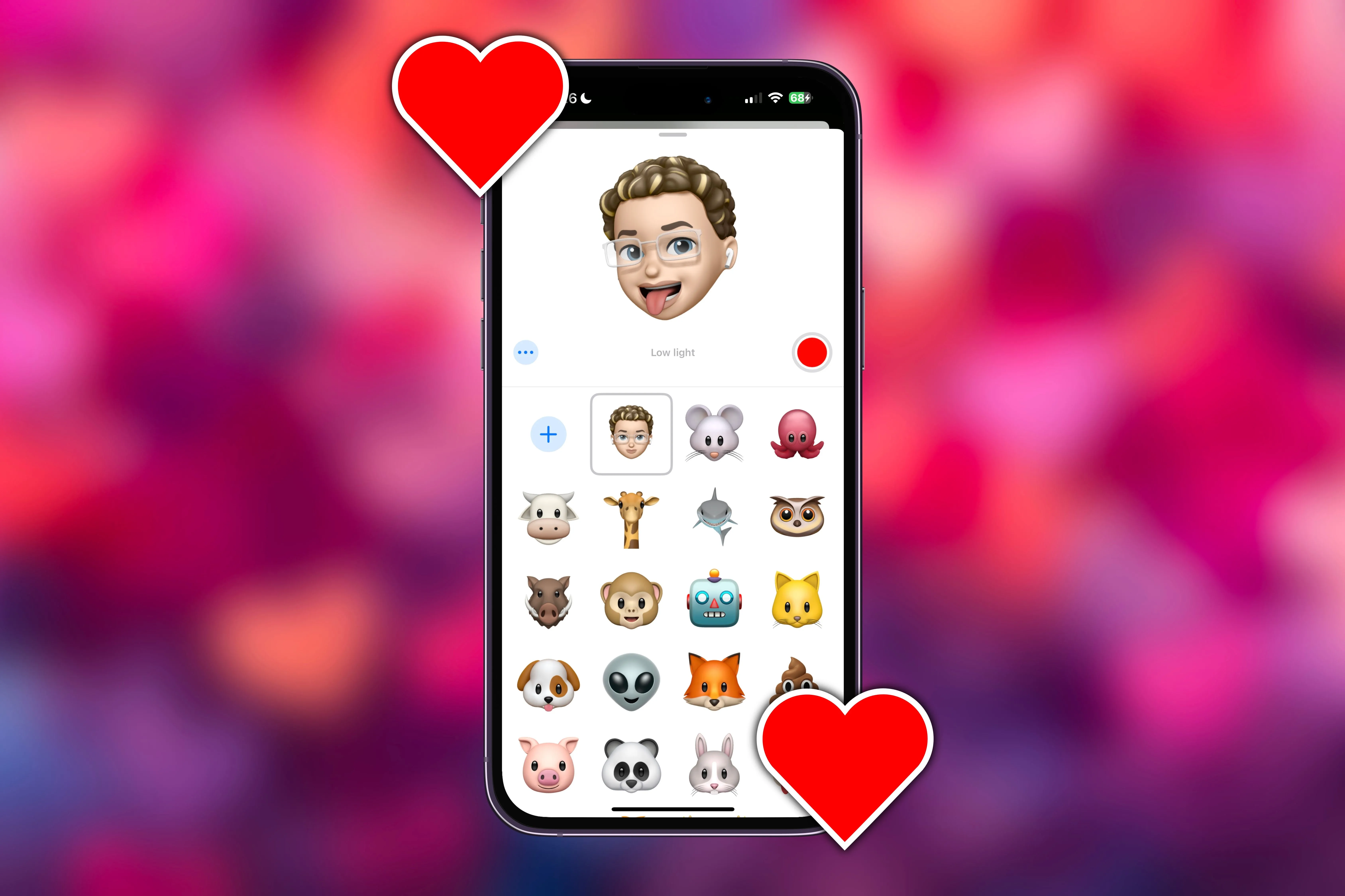 Giao diện tạo video Memoji trong iMessage trên iPhone với các trái tim bao quanh.