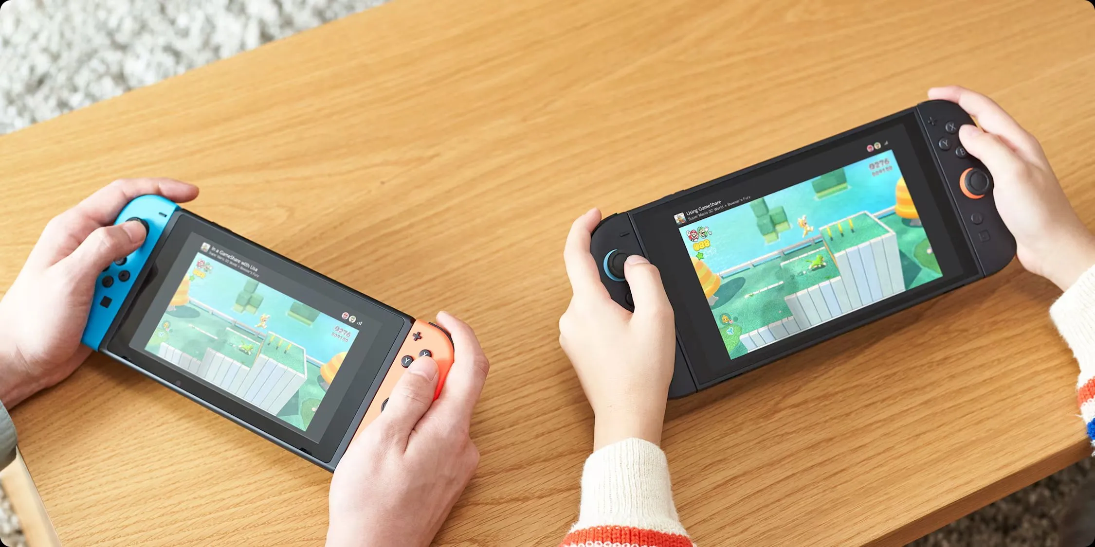 Hai máy Nintendo Switch (đời đầu và Switch 2) được kết nối, minh họa tính năng GameShare cho phép chơi đa người trên nhiều thiết bị.