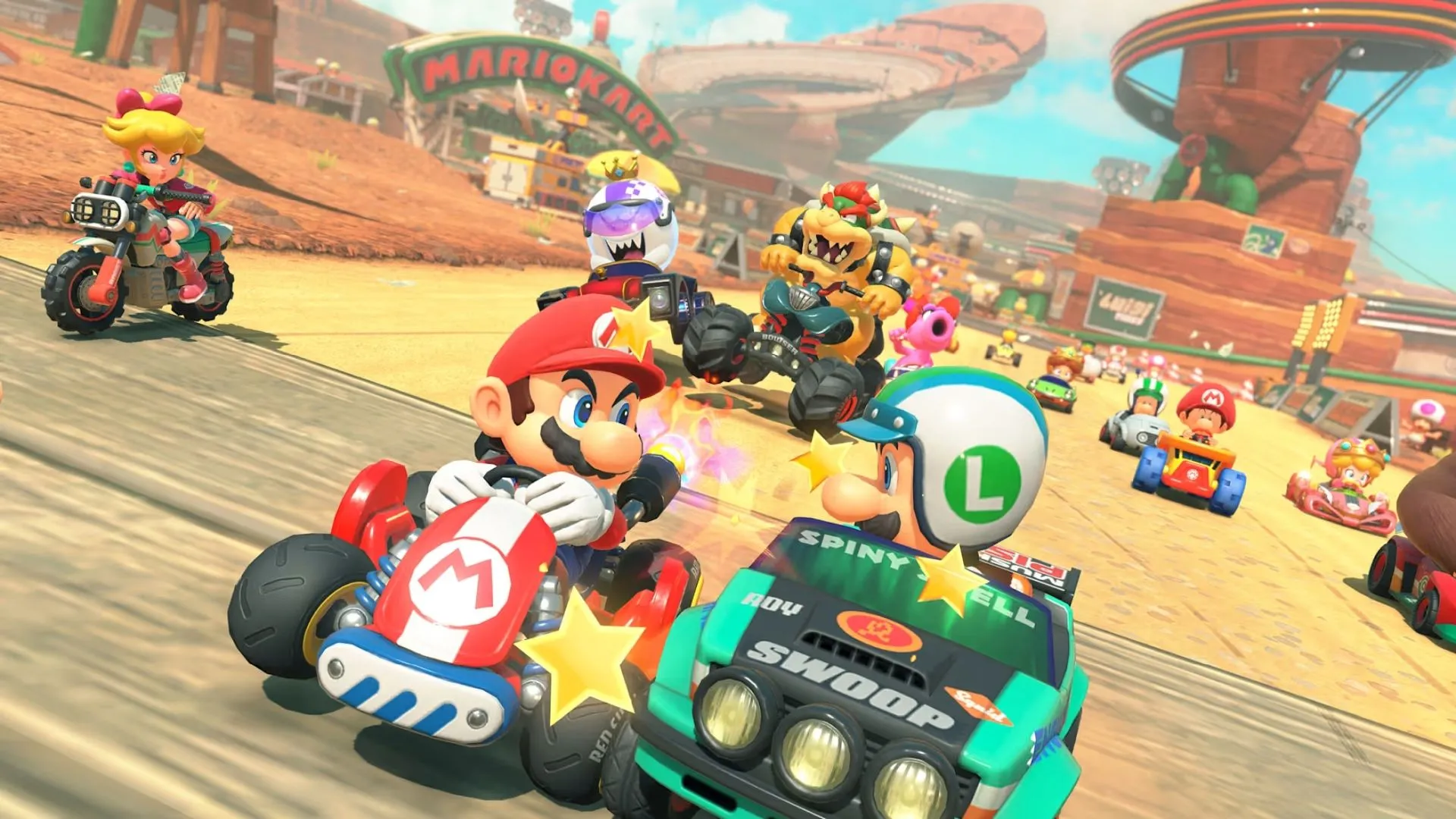 Toad và các nhân vật khác đua xe trên đường đua thành phố trong Mario Kart World.