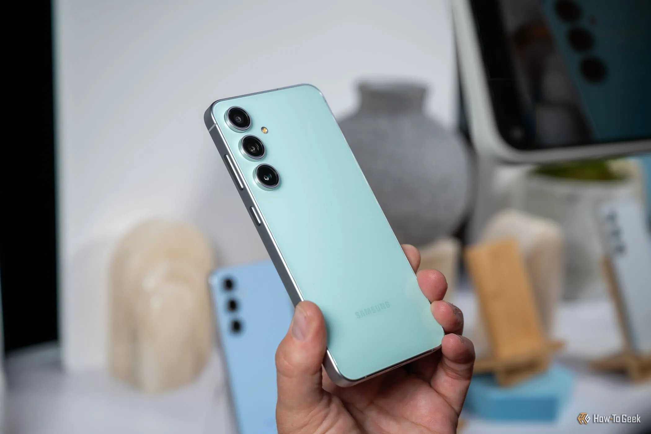 Một người đang cầm điện thoại Samsung Galaxy S24 FE màu xanh lá, minh họa cho sự phổ biến của các dòng smartphone tầm trung chất lượng tốt ngày nay.