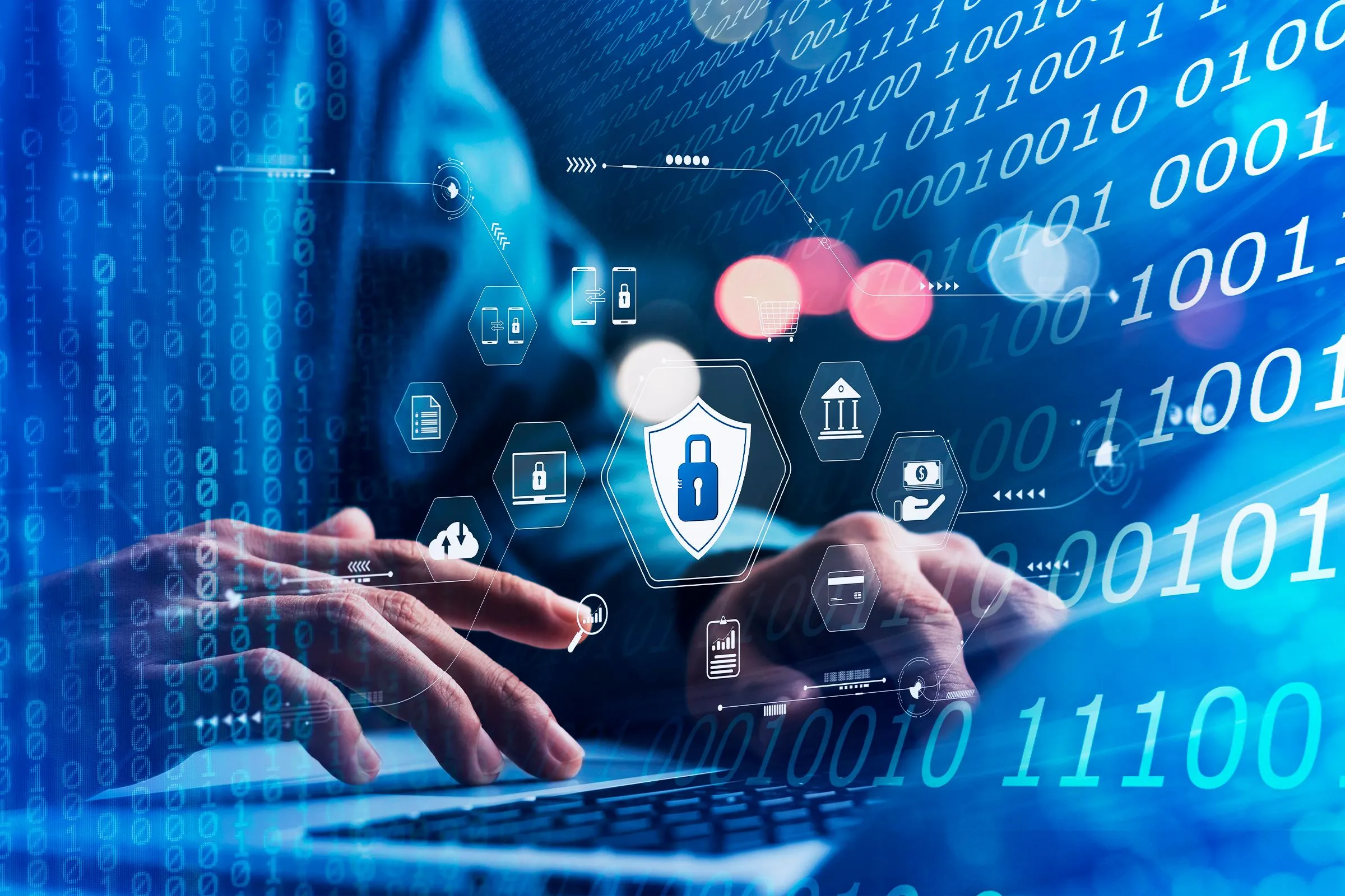 Bàn tay người dùng máy tính xách tay với các biểu tượng mã hóa dữ liệu và mã nhị phân